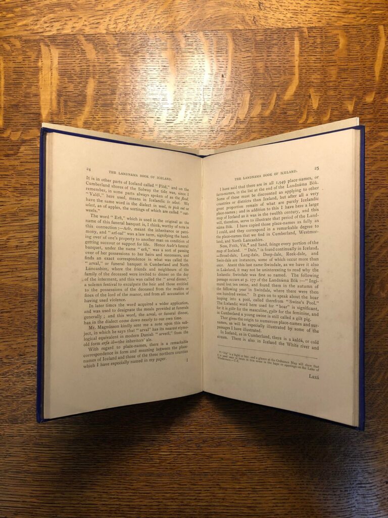 Image of a book laying open in a cradle