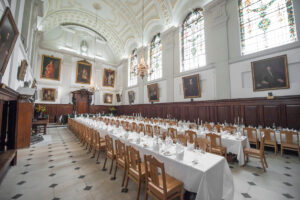 Dining Hall laid up for a banquet with oak chairs