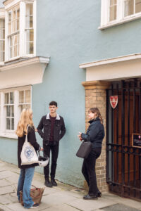 three students talking outside Carrodus Quad
