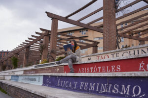 woman sitting reading on steps that look like books