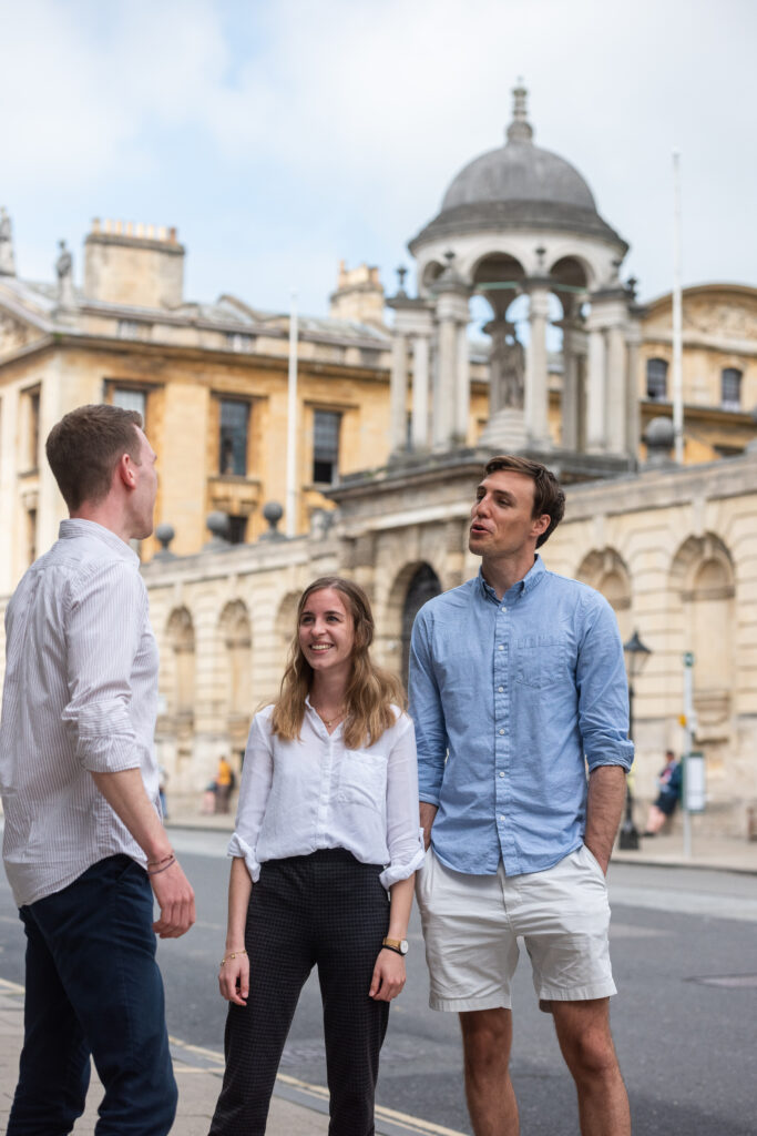 Graduate students standing on the High Street outside Queen's