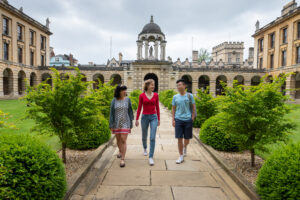 students walking away from the cupola in front quad