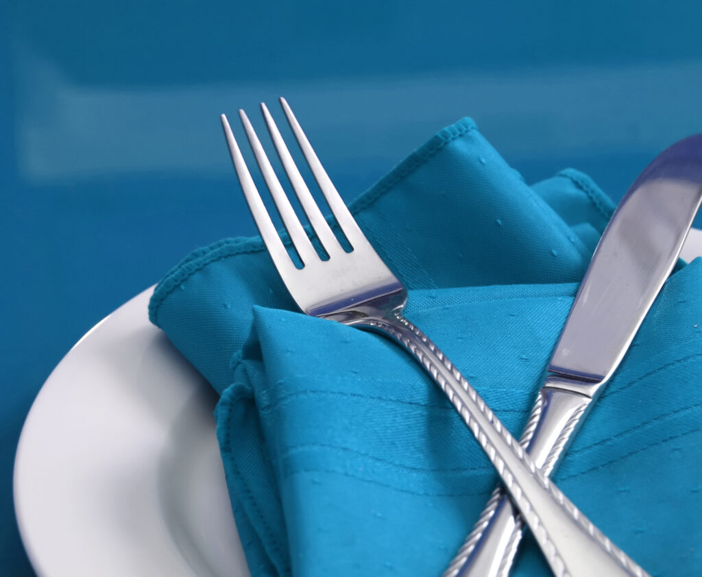 knife and fork on blue place setting