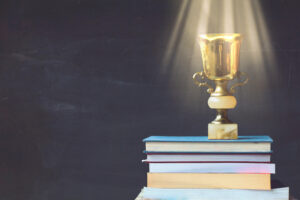 a trophy on top of a stack of books