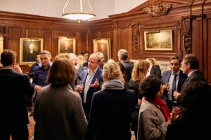 People standing and talking in the Magrath Room