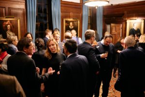 People standing and talking in the Magrath Room