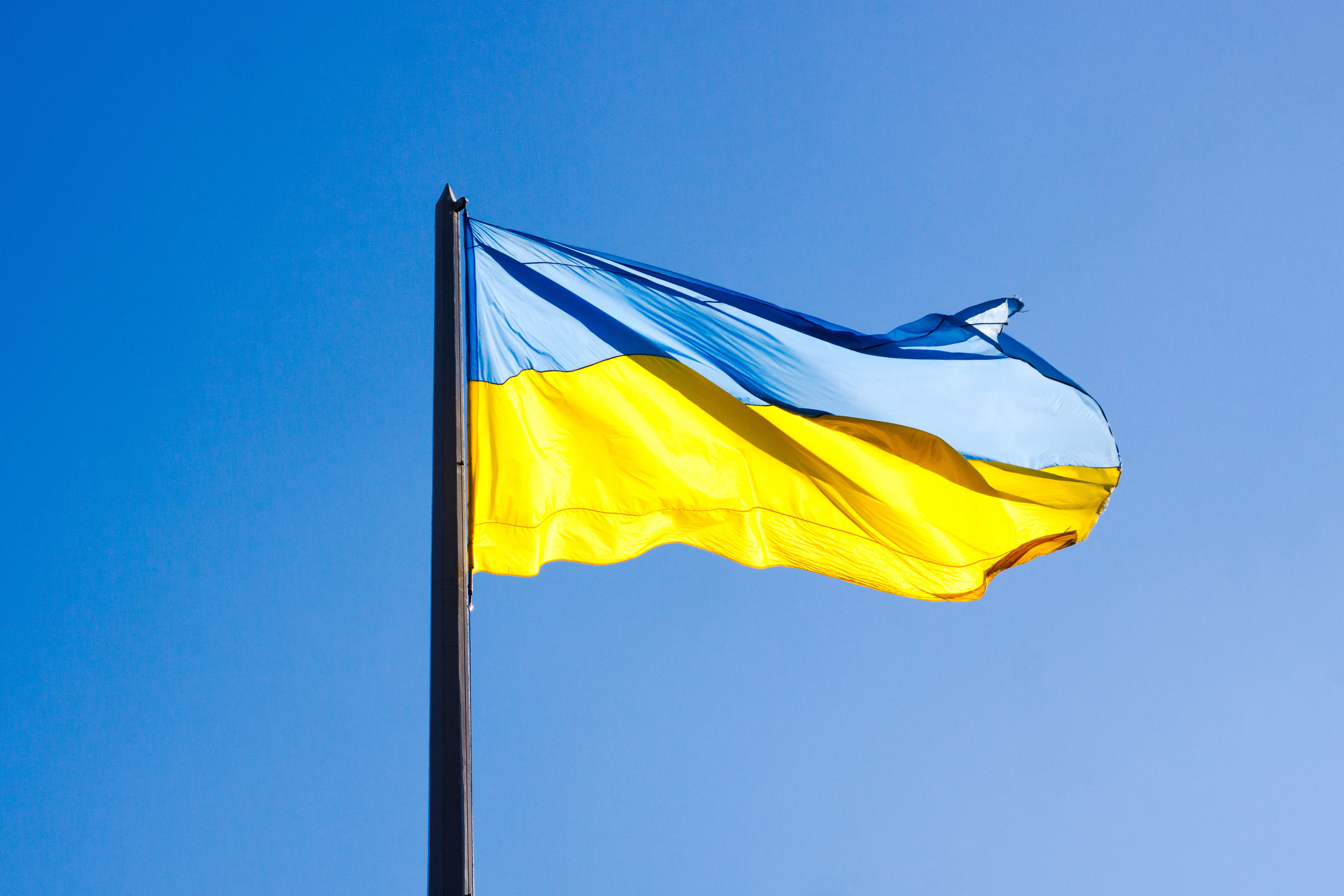 The Ukrainian flag against a blue sky
