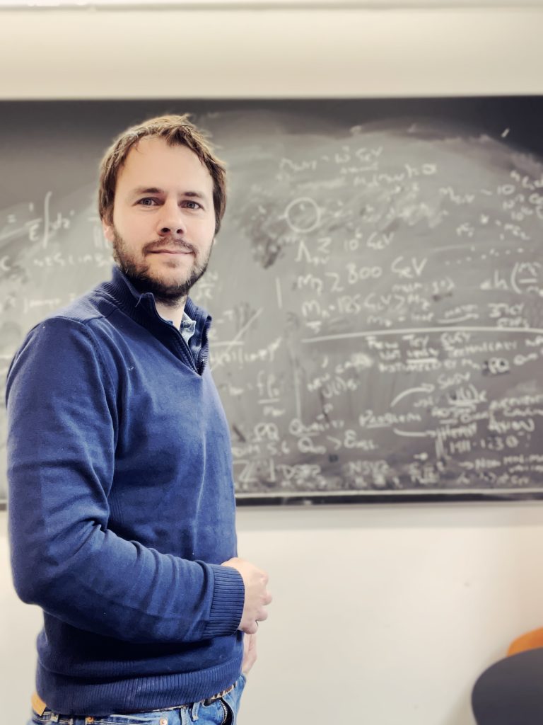 James Unwin standing in front of a blackboard