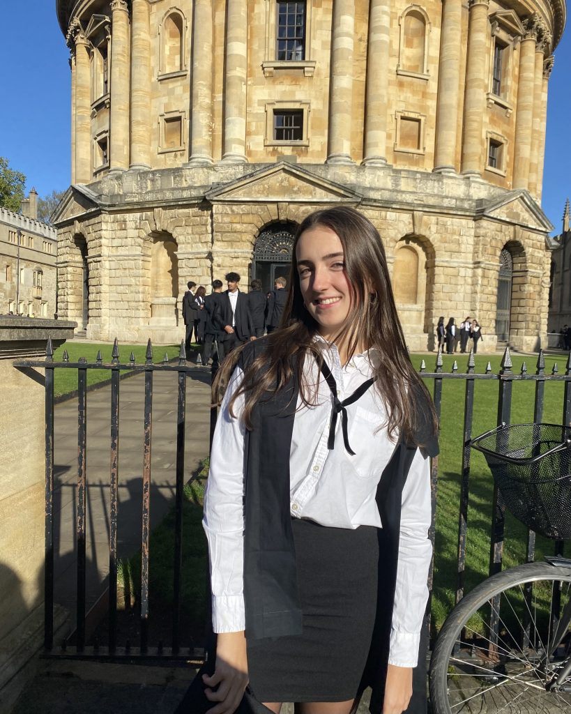 Marina in sub fusc academic dress outside the Radcliffe Camera library