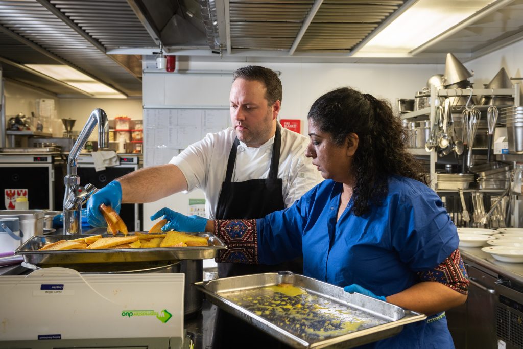 Asma Khan cooking with Head Chef Sean Ducie in the College kitchen