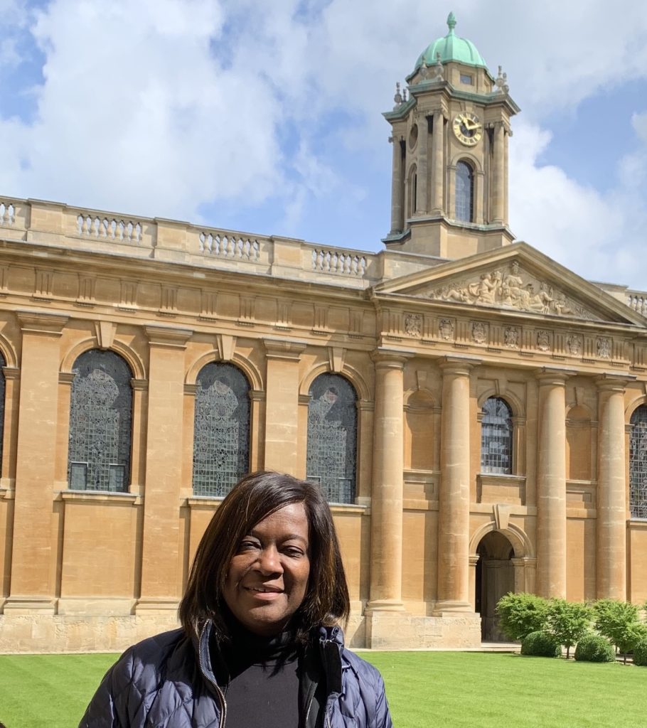 Jacky Wright pictured in Front Quad with the clock tower in the background
