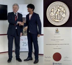 Devajna K Gopal receiving his prize pictured alongside the prize certificate