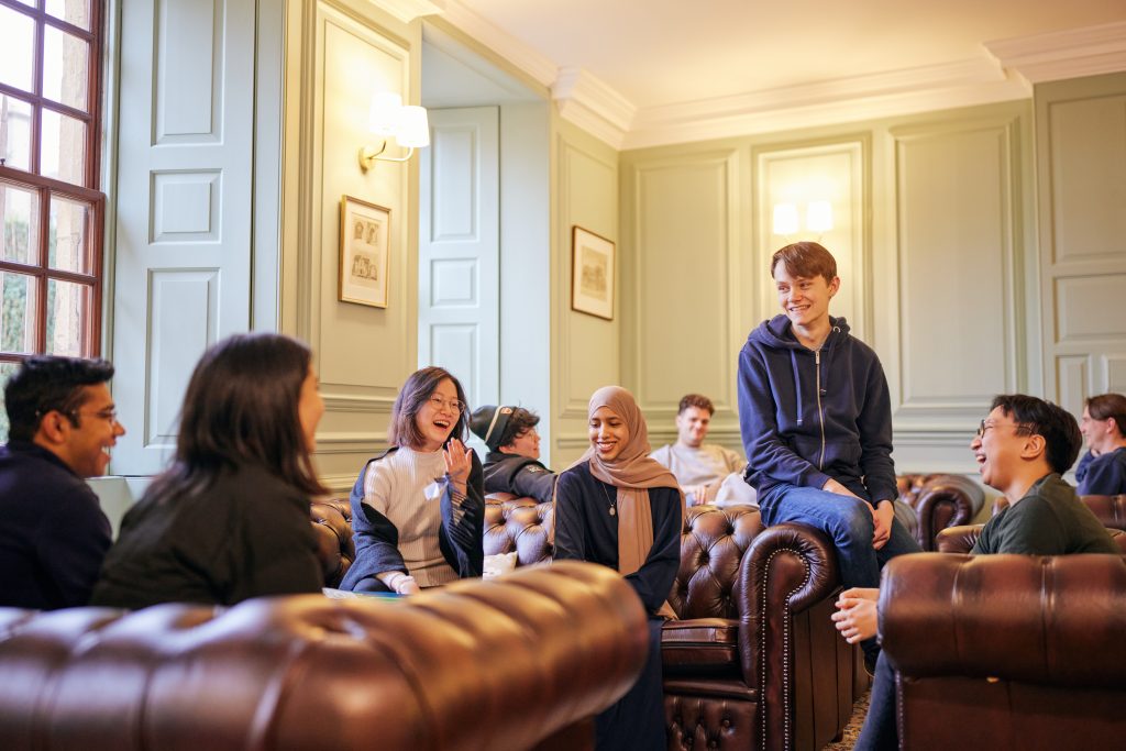 current students relaxing on the sofas in the Junior Common Room