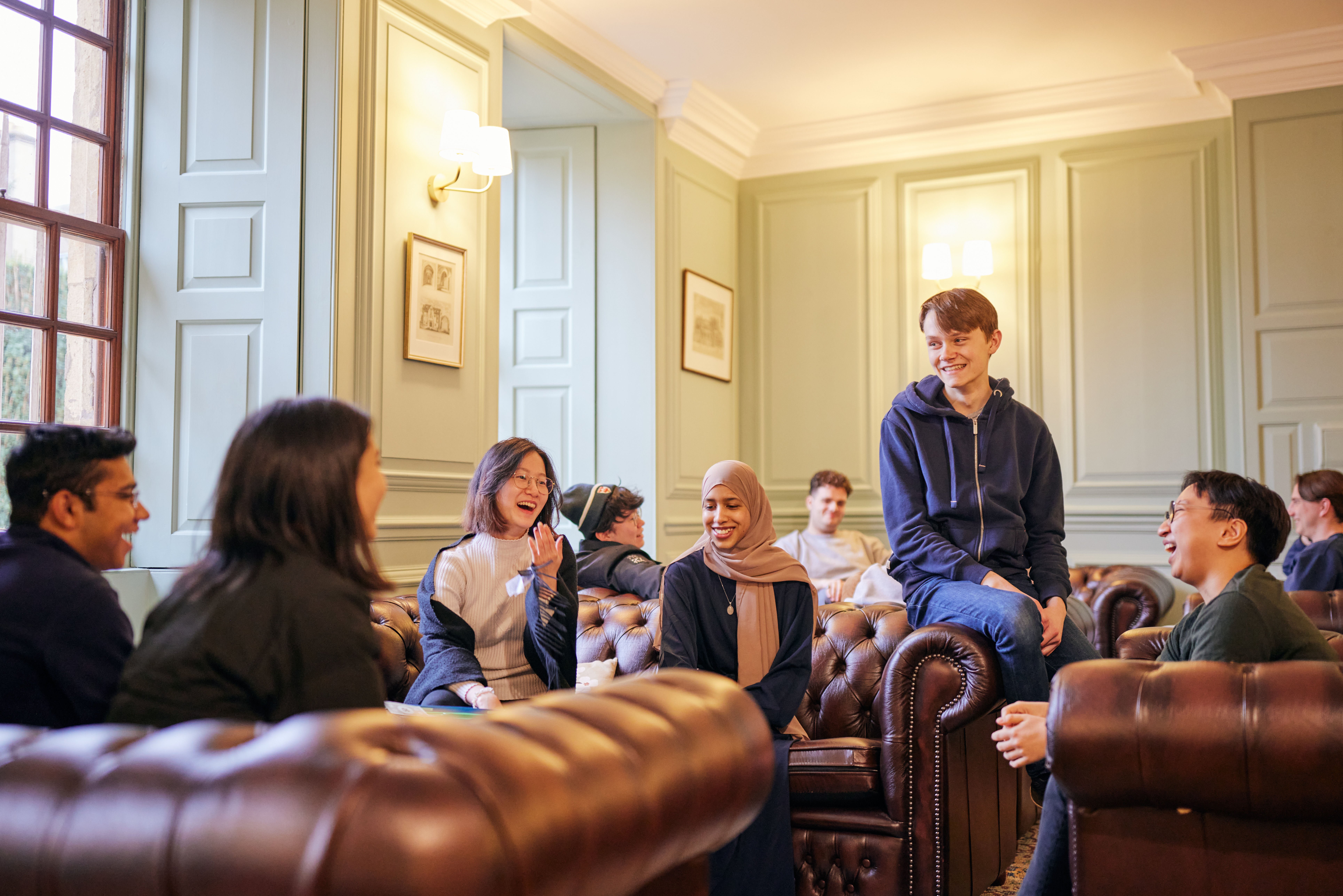 current students relaxing on the sofas in the Junior Common Room