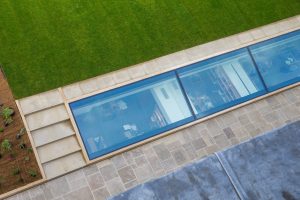 the skylight shown from above looking down into the new library with the grass of the Provost's Garden next to it