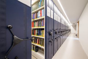 blue roller rack book shelves open at the near end to show bookcases