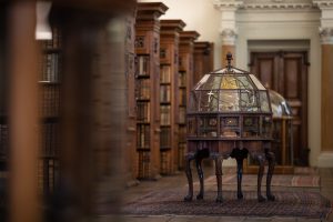 The Upper Library showing an orrery and lines of bookcases
