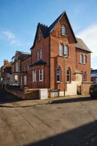 James Street exterior: a red brick three-storey house on the corner of two streets