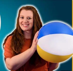 A photo of Prof Kirsty Duffy holding a beach ball with a blue background