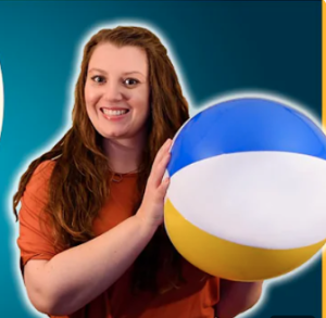 A photo of Prof Kirsty Duffy holding a beach ball with a blue background