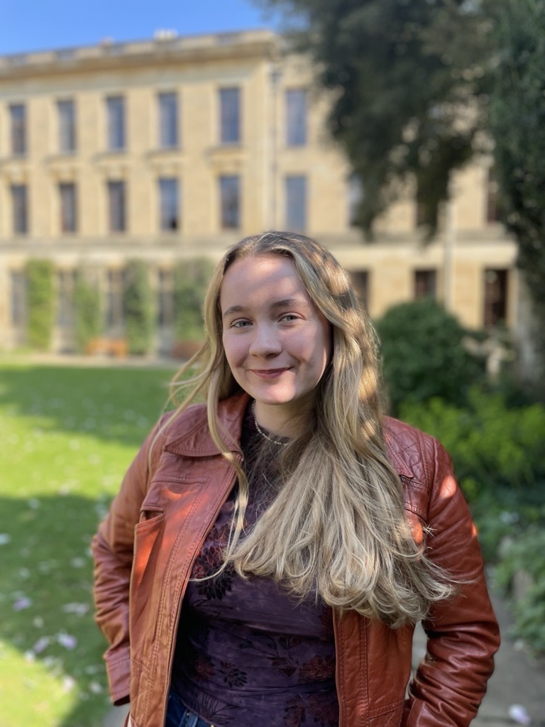 Profile photo for Kyla Murray who stands in the gardens at The Queen's College