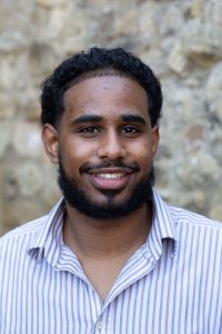 profile shot of Mohammad Abdulhamid. Mohammad smiles to the camera.
