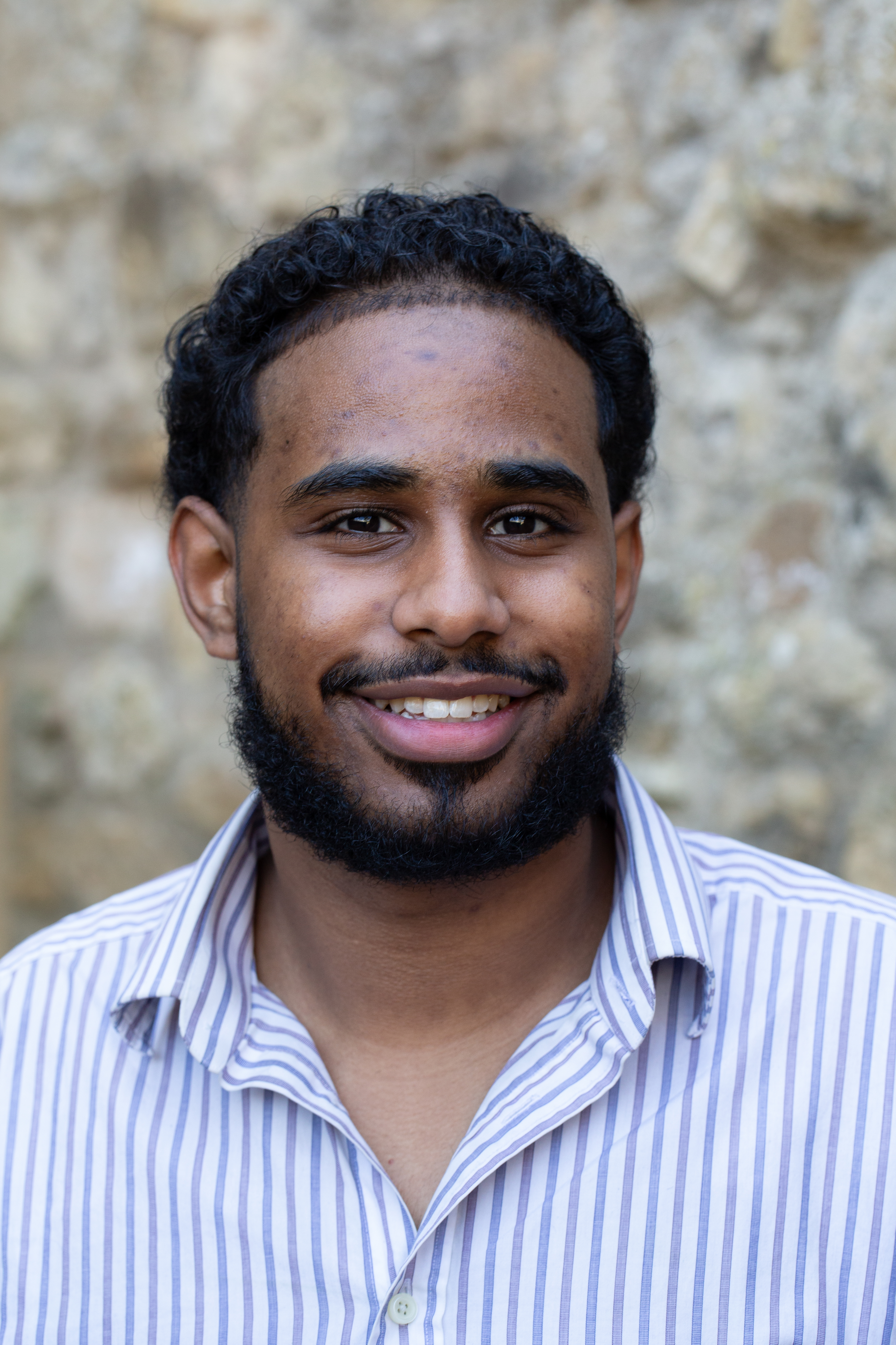 profile shot of Mohammad Abdulhamid. Mohammad smiles to the camera.