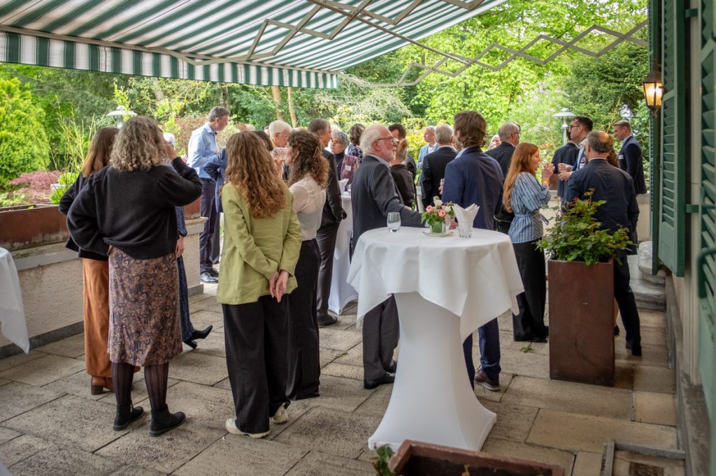 Guests mingling on the Residence terrace during the drinks reception.