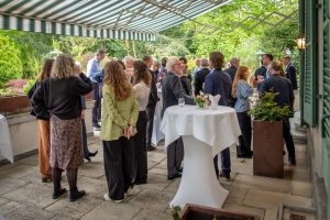 Guests mingling on the Residence terrace during the drinks reception.