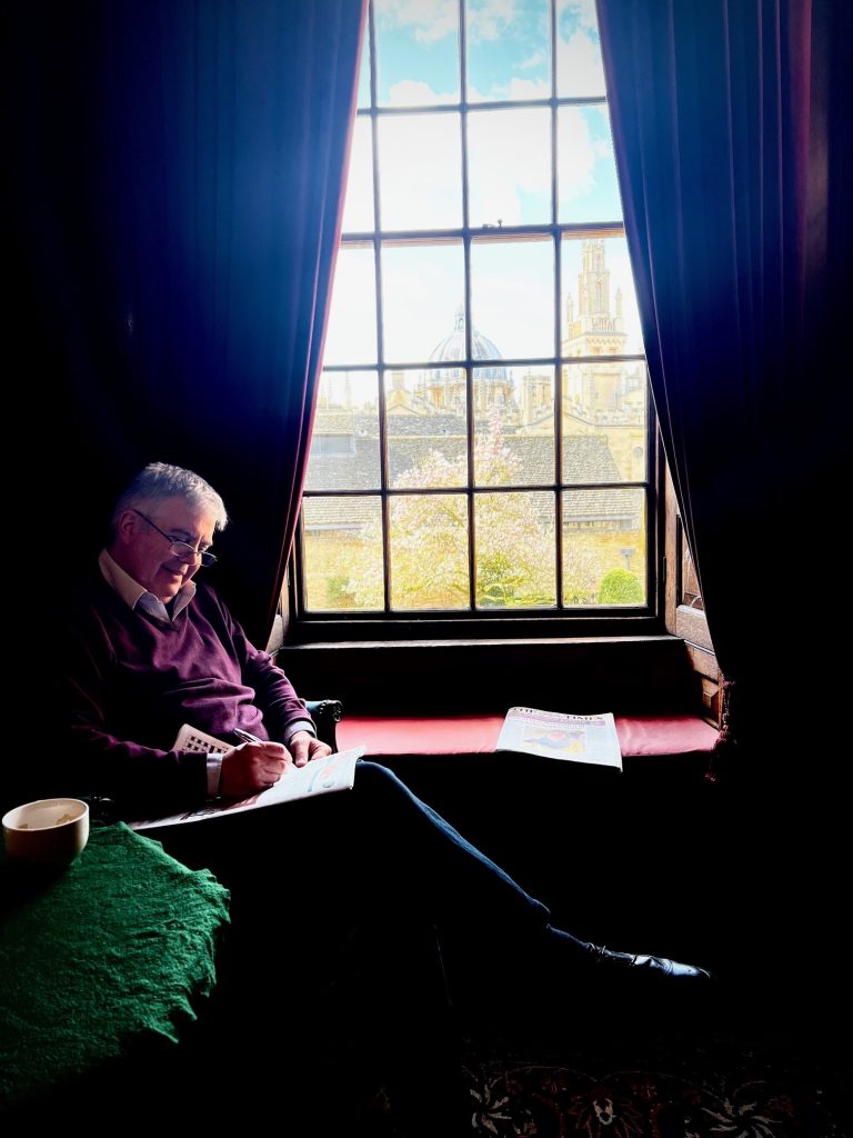 Prof Robert Taylor seated in the window of the Senior Common Room