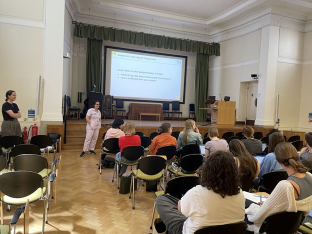 students seated lecture-theatre style in front of a large screen for the year abroad translation training