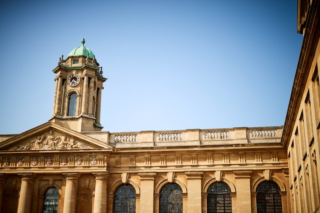 the clock tower and part of Front Quad against a light blue sky