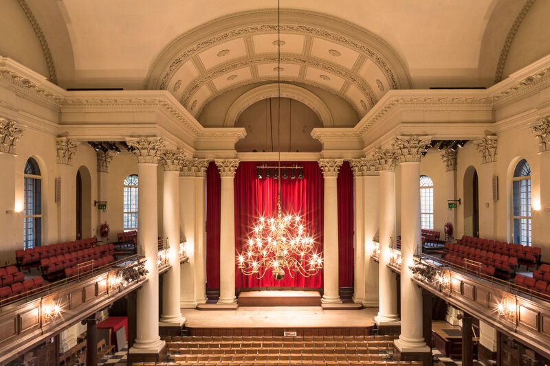 Inside of Smith Square Hall with lit chandelier