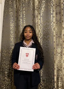 Chioma holding her ABP certificate