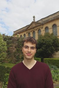 profile photo of Tom with Queen's Library building and gardens in the background