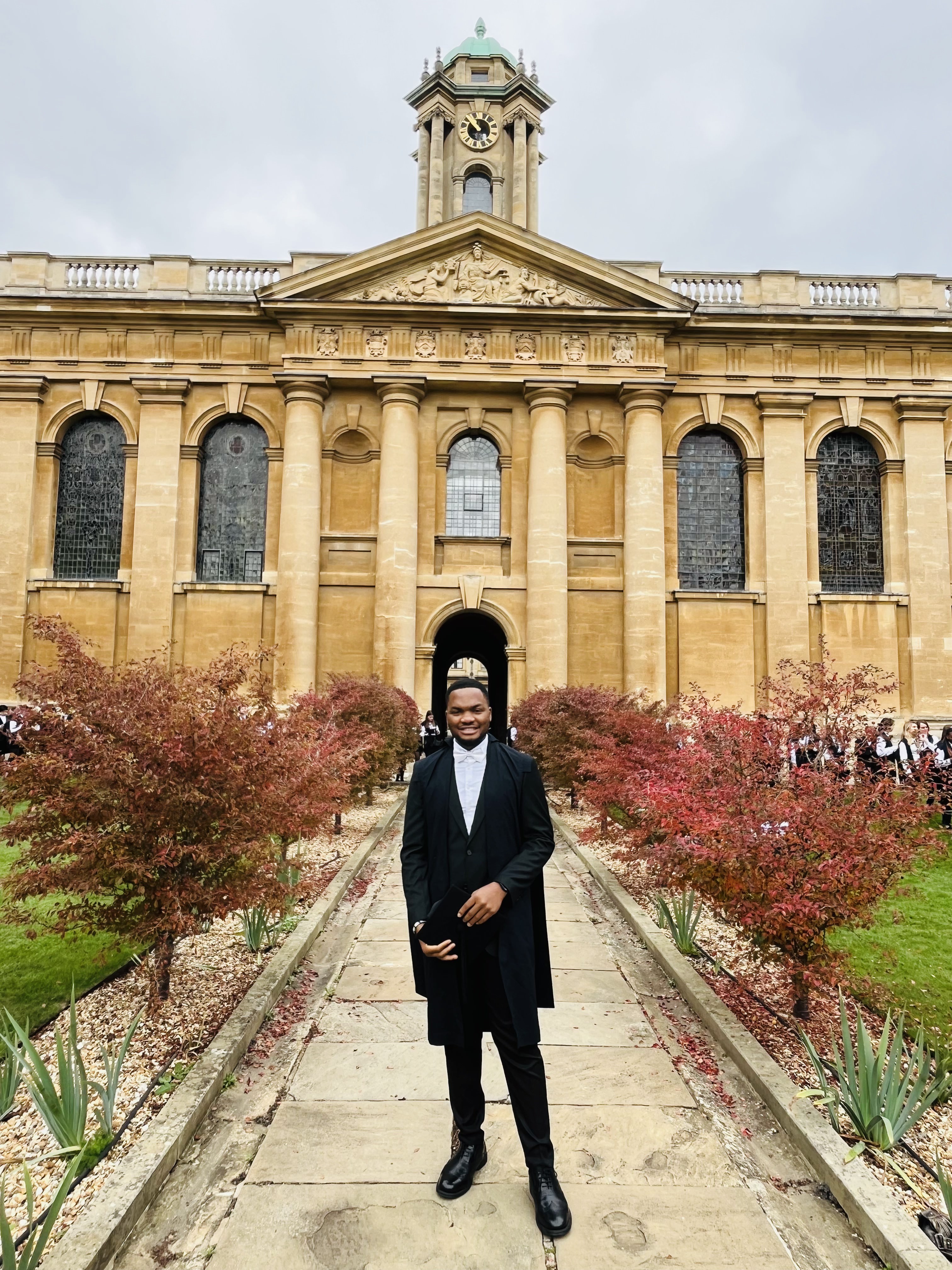 Graduate student Great standing in Front Quad at Queen's wearing subfusc academic dress