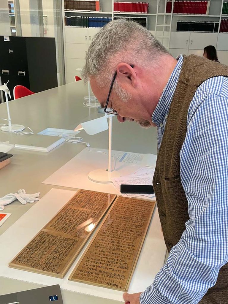 Professor Parkinson with the main papyrus of The Life of Sinuhe in the Ägyptisches Museum, Berlin, 2025 (Credit: Biri Fay)