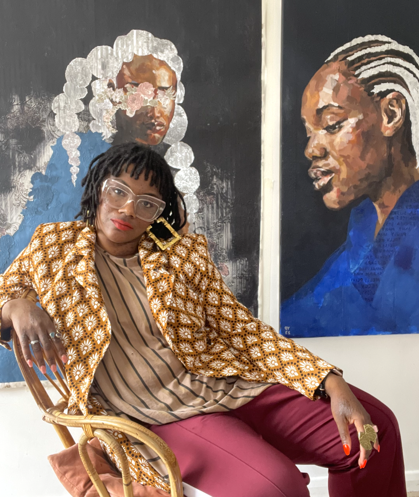 Artist Yvadney Davis sitting in front of her work