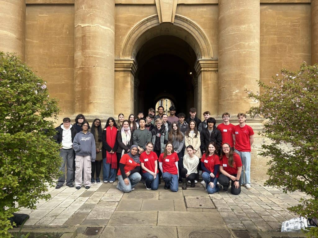 A school group pictured in Front Quad with the student ambassadors wearing red t-shirts