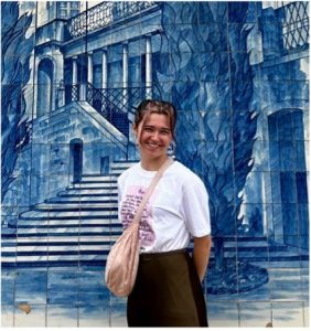 Emily Dicker pictured on her year abroad in front of a blue-tiled building