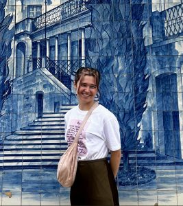 Emily Dicker pictured on her year abroad in front of a blue-tiled building