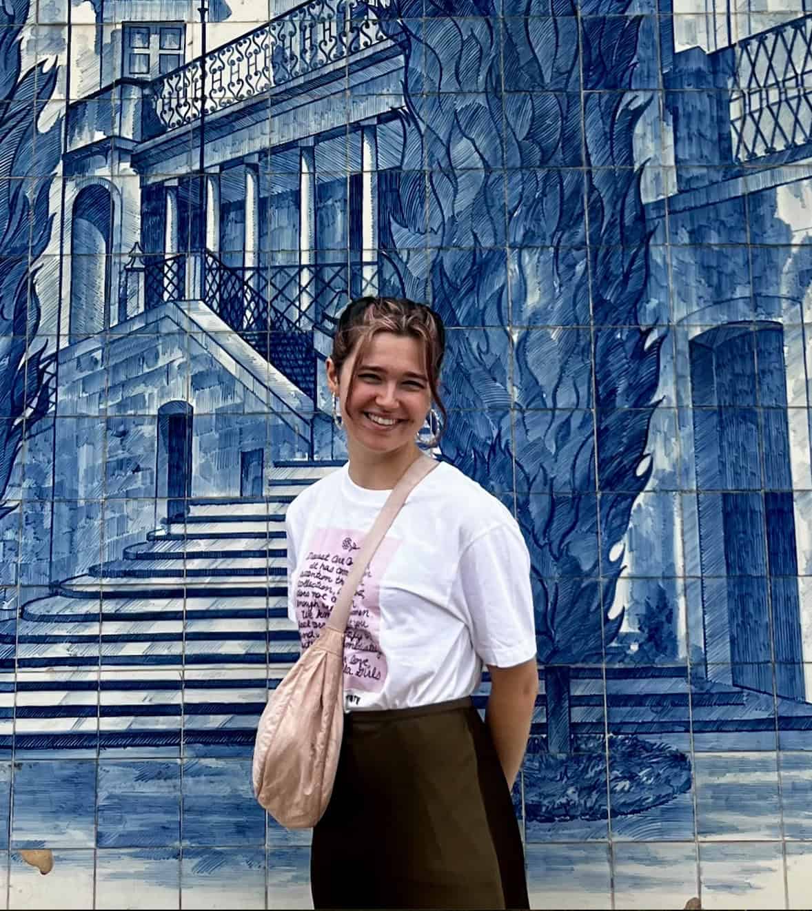 Emily Dicker pictured on her year abroad in front of a blue-tiled building