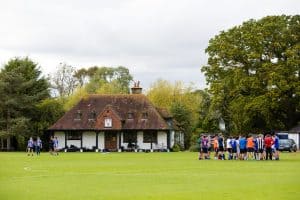 College spotsground with students in football kit