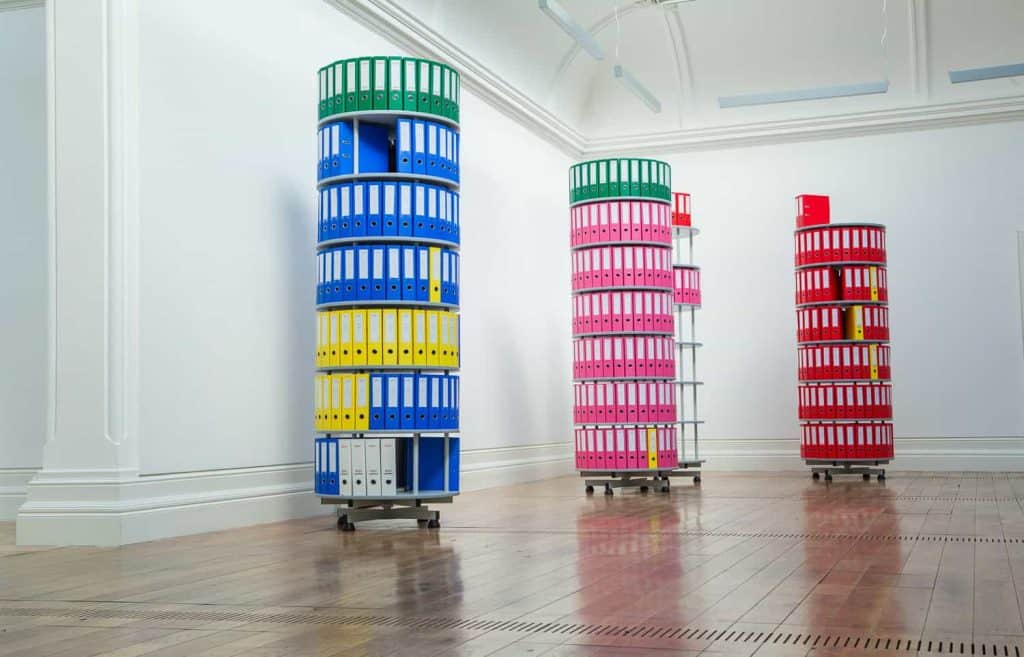 Fugitive I (Dignitas), 2026
Replicated Dignitas assisted-dying paperwork, rotating filing towers, coloured lever-arch folders and spine labels. Four units, 80 × 234 cm each by Rafael Pérez Evans